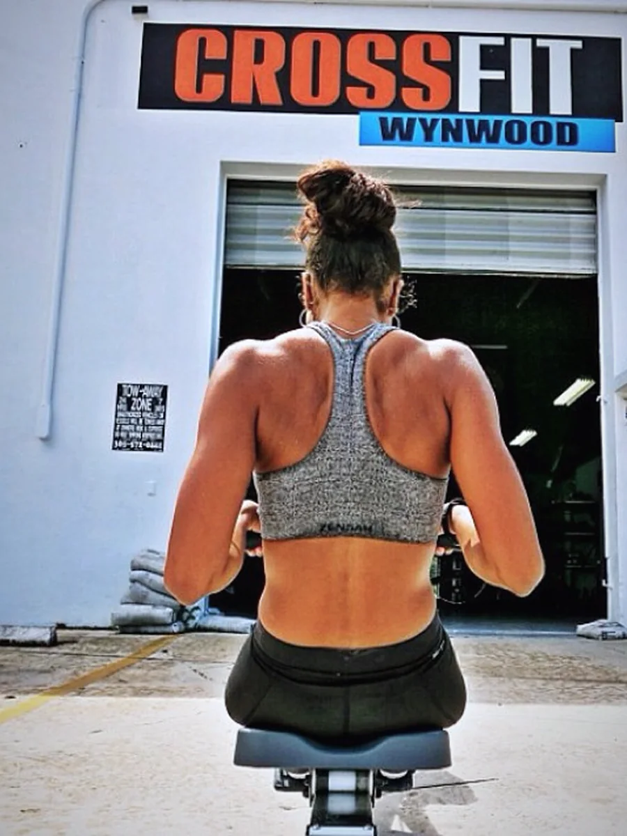 A member training outside the box beneath the CrossFit Wynwood sign — strength, made in Little River